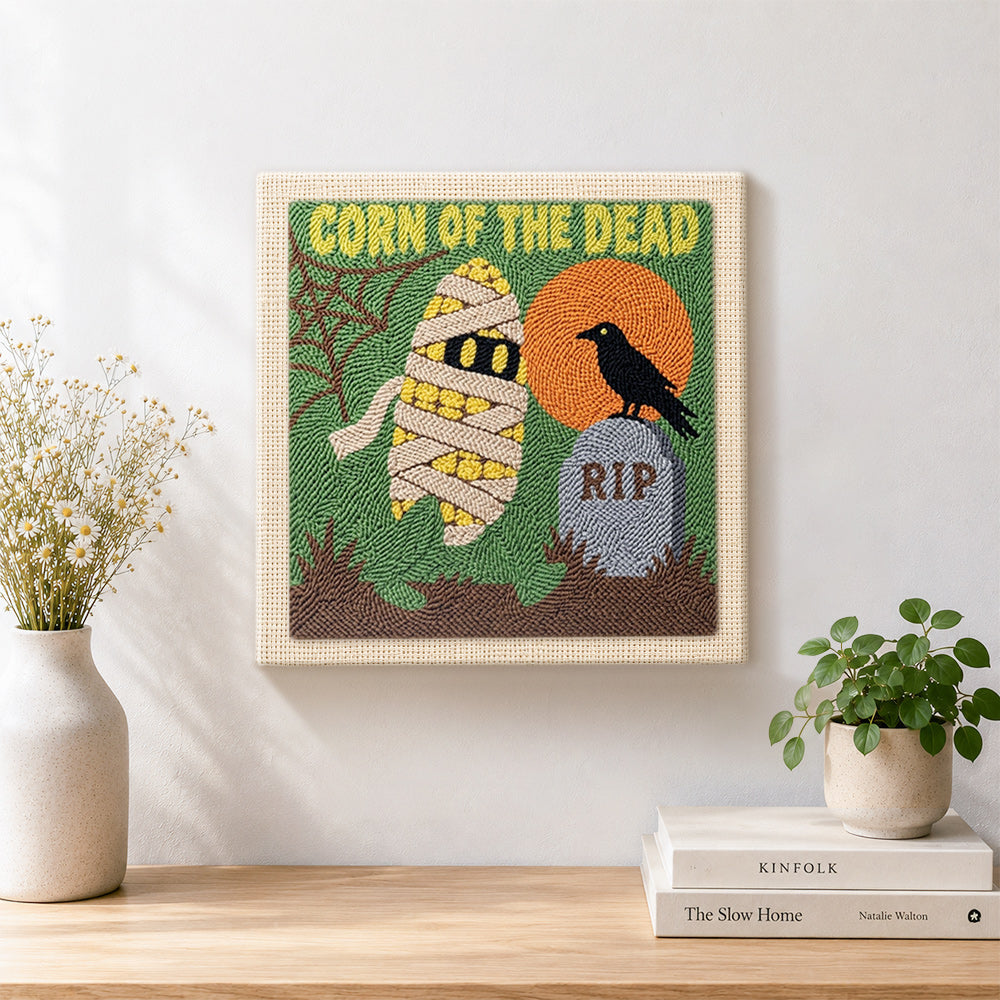 Finished spooky mummy corn artwork displayed on a wall