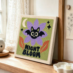 Spooky night bloom punch needle artwork displayed on a table