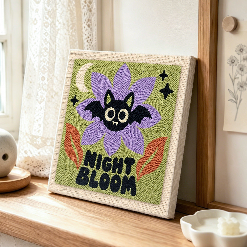 Spooky night bloom punch needle artwork displayed on a table