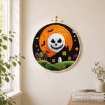 Spooky skeleton face moon needle felt wall art displayed in a bright home interior