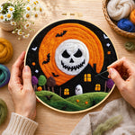 Creating the spooky skeleton face moon wool painting by hand with a felting needle