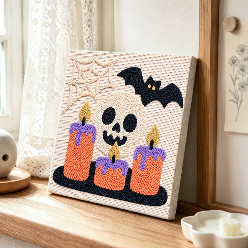 Spooky skull candles punch needle artwork displayed on a table