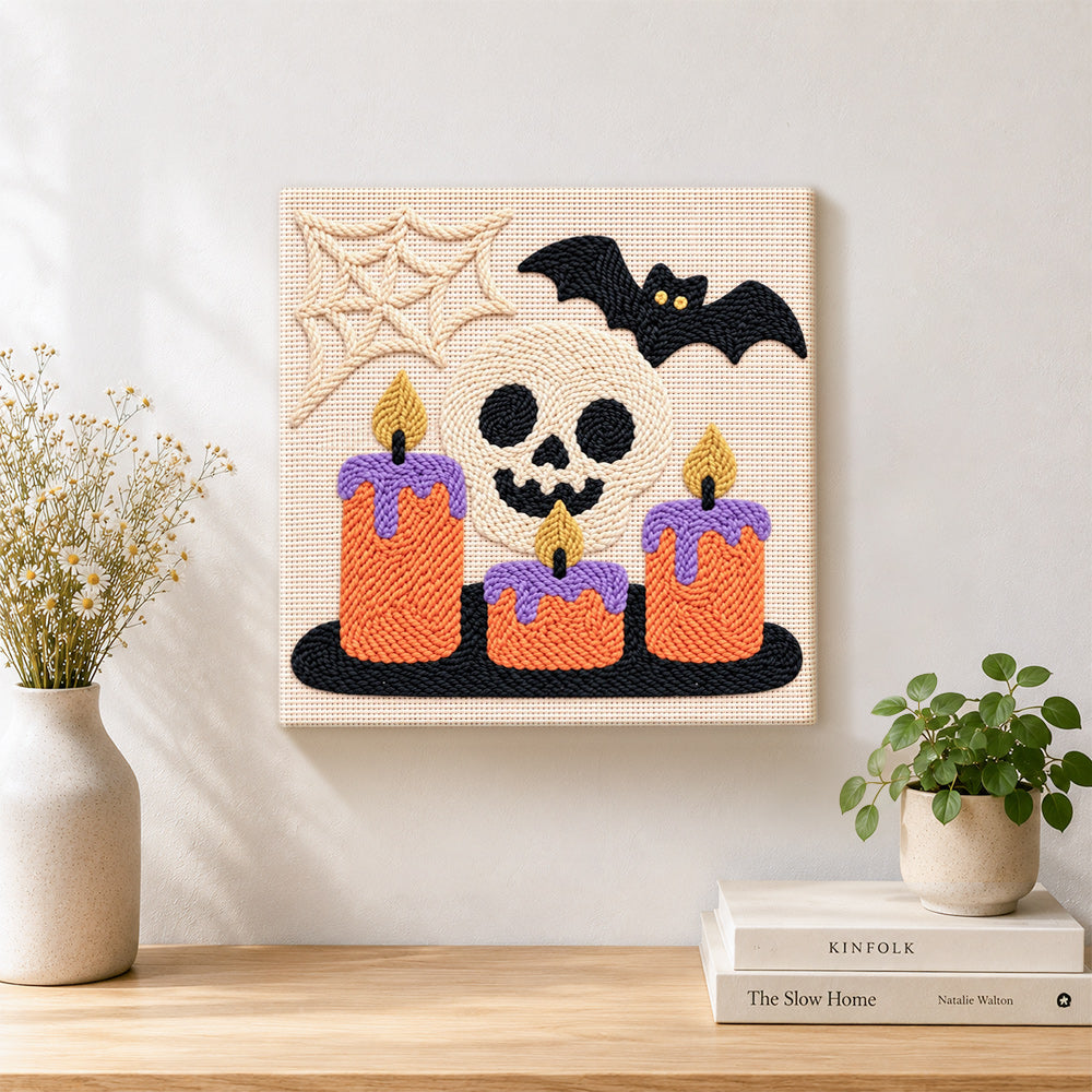 Finished spooky skull candles artwork displayed on a wall