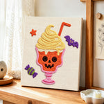 Spooky skull ice cream cup punch needle artwork displayed on a table