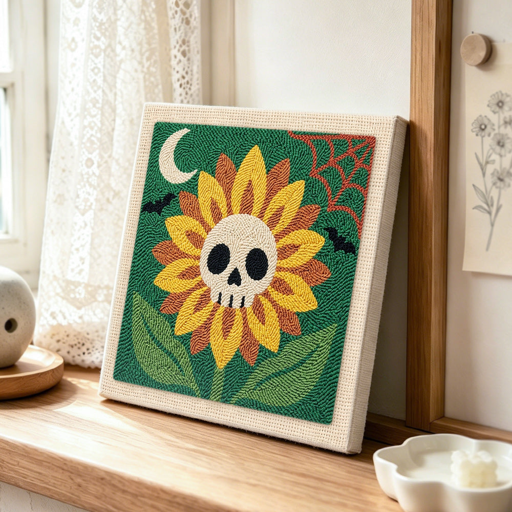 spooky sunflower with skull center punch needle artwork displayed on a table
