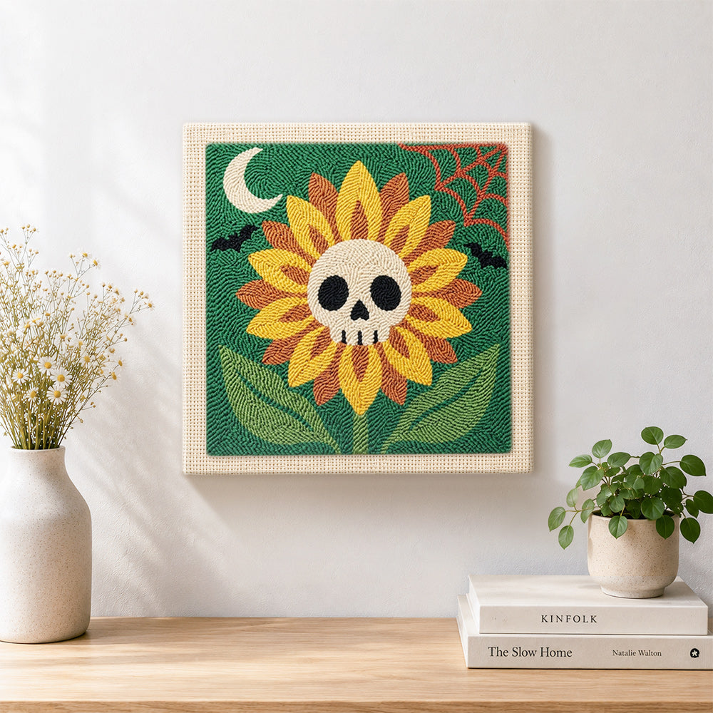 Finished spooky sunflower with skull center artwork displayed on a wall