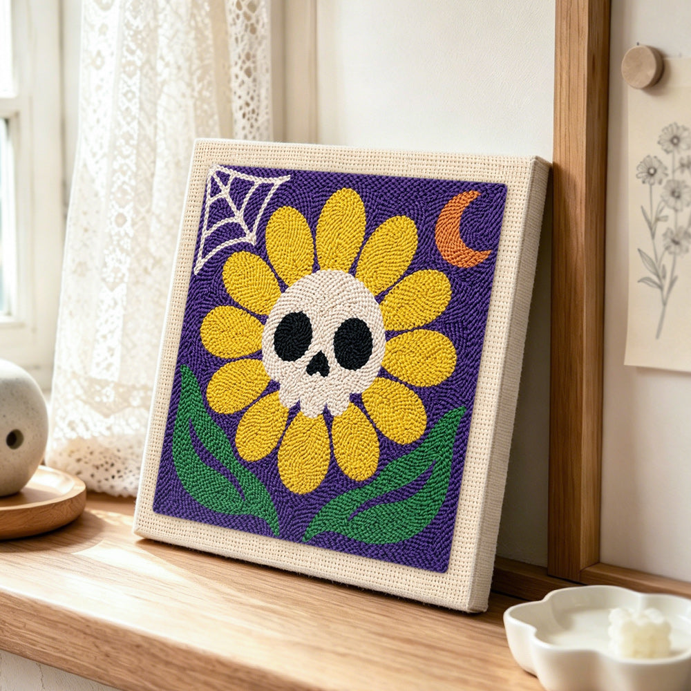 Spooky sunflower with skull punch needle artwork displayed on a table