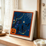 Spooky tree and ravens punch needle artwork displayed on a table