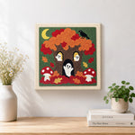 Finished spooky tree with little ghosts artwork displayed on a wall