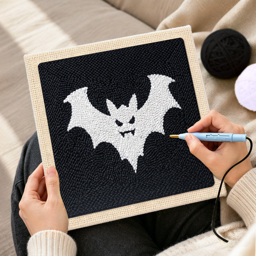 Creating handmade spooky white bat punch needle artwork