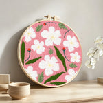 Spring blossom punch needle artwork displayed on a table