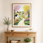 Finished spring country village cross stitch artwork displayed as home decor