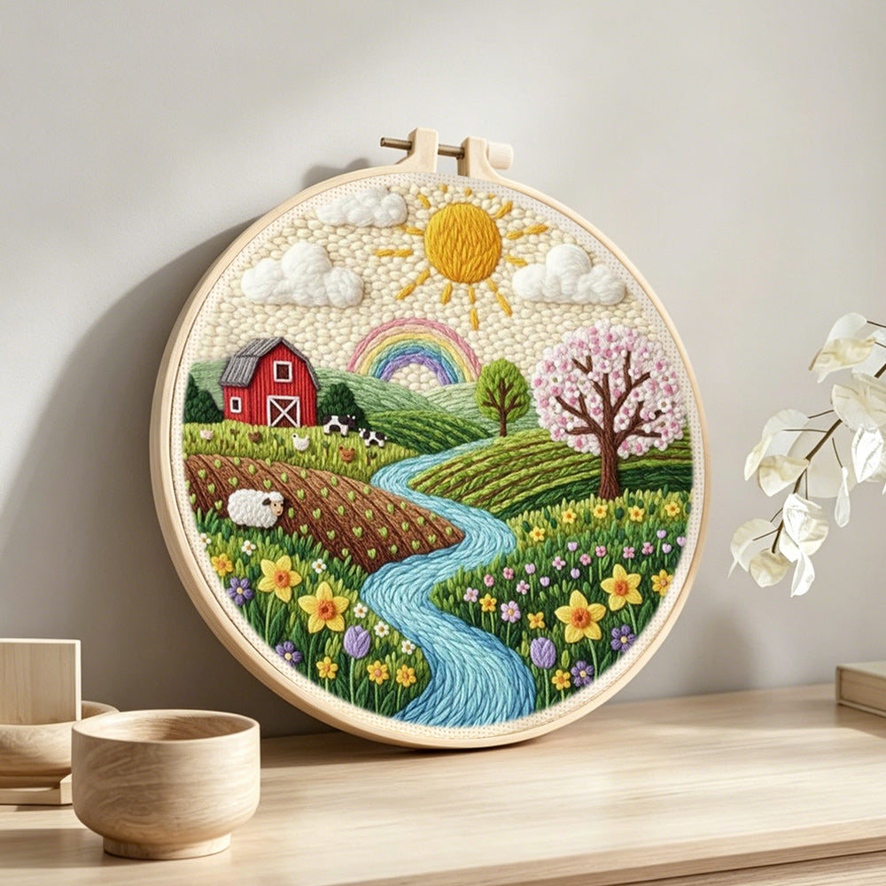 Spring countryside farm and rainbow punch needle artwork displayed on a table