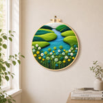 Spring river and green flowers needle felt wall art displayed in a bright home interior