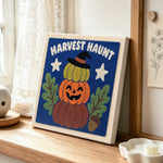 Stacked harvest pumpkins punch needle artwork displayed on a table