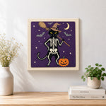Finished standing skeleton cat artwork displayed on a wall