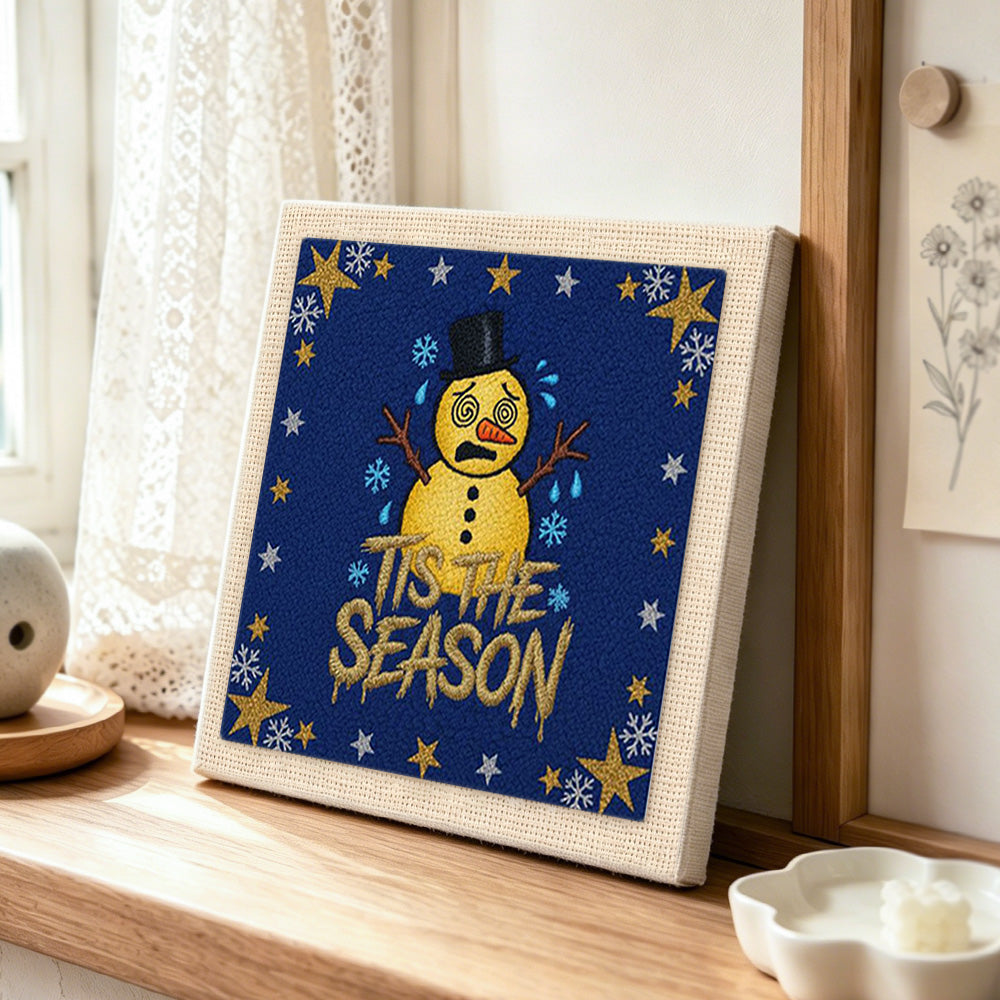 Star border sad snowman punch needle artwork displayed on a table
