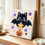 Star‑holding bat punch needle artwork displayed on a table