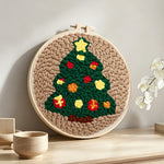 Star topped christmas tree punch needle artwork displayed on a table