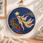 Starry koi fish embroidery hoop wall art displayed as warm and cozy handmade home decor