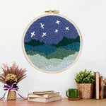 Finished starry mountain night landscape artwork displayed on a wall