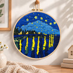 Starry night lakeside view embroidery hoop wall art displayed as warm and cozy handmade home decor