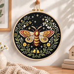 Starry night moth embroidery hoop wall art displayed as warm and cozy handmade home decor