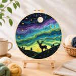 Finished starry night stag silhouette needle felting displayed on a wooden easel