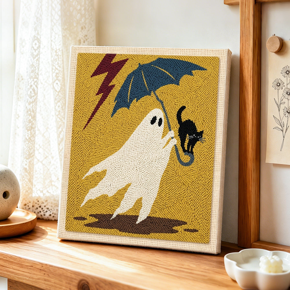 Stormy ghost with black cat punch needle artwork displayed on a table