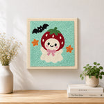 Finished strawberry ghost artwork displayed on a wall