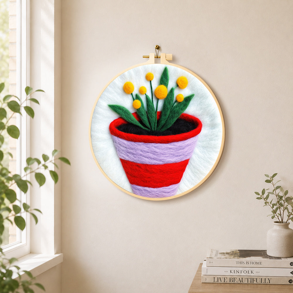 Striped pot with yellow flowers needle felt wall art displayed in a bright home interior