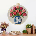 Finished striped vase with pink tulips artwork displayed on a wall