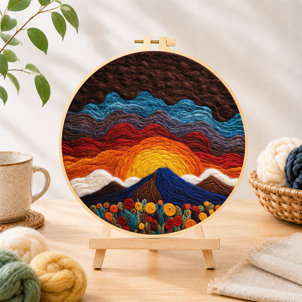 Finished stunning sunrise over wavy hills needle felting displayed on a wooden easel