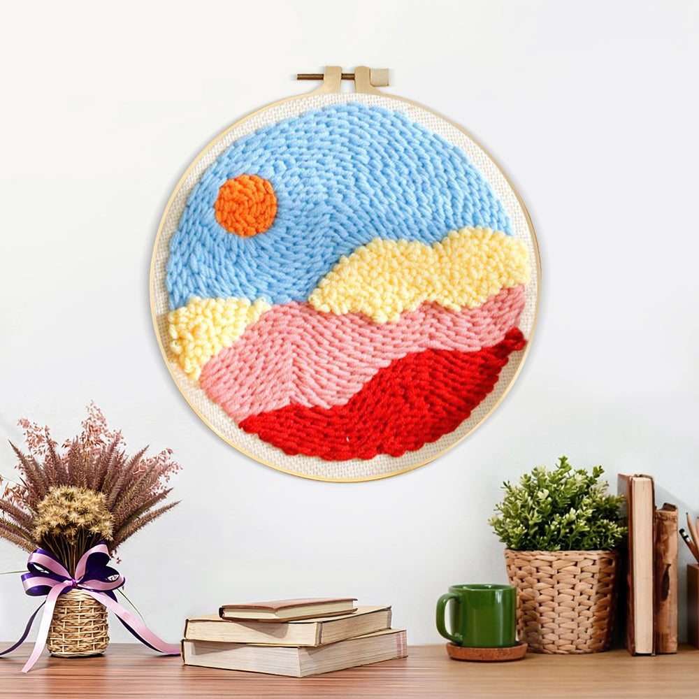 Finished sun over colorful mountains and clouds artwork displayed on a wall