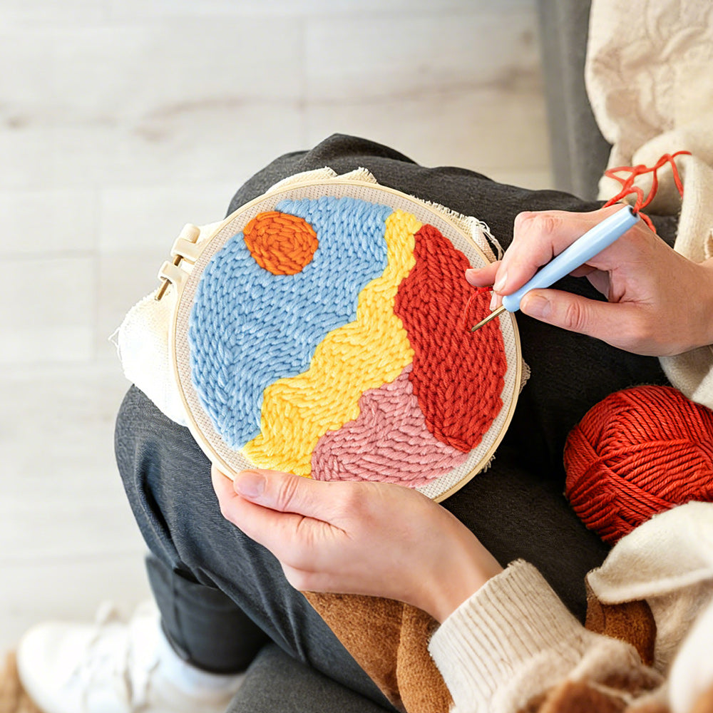 Creating handmade sun over colorful mountains punch needle artwork