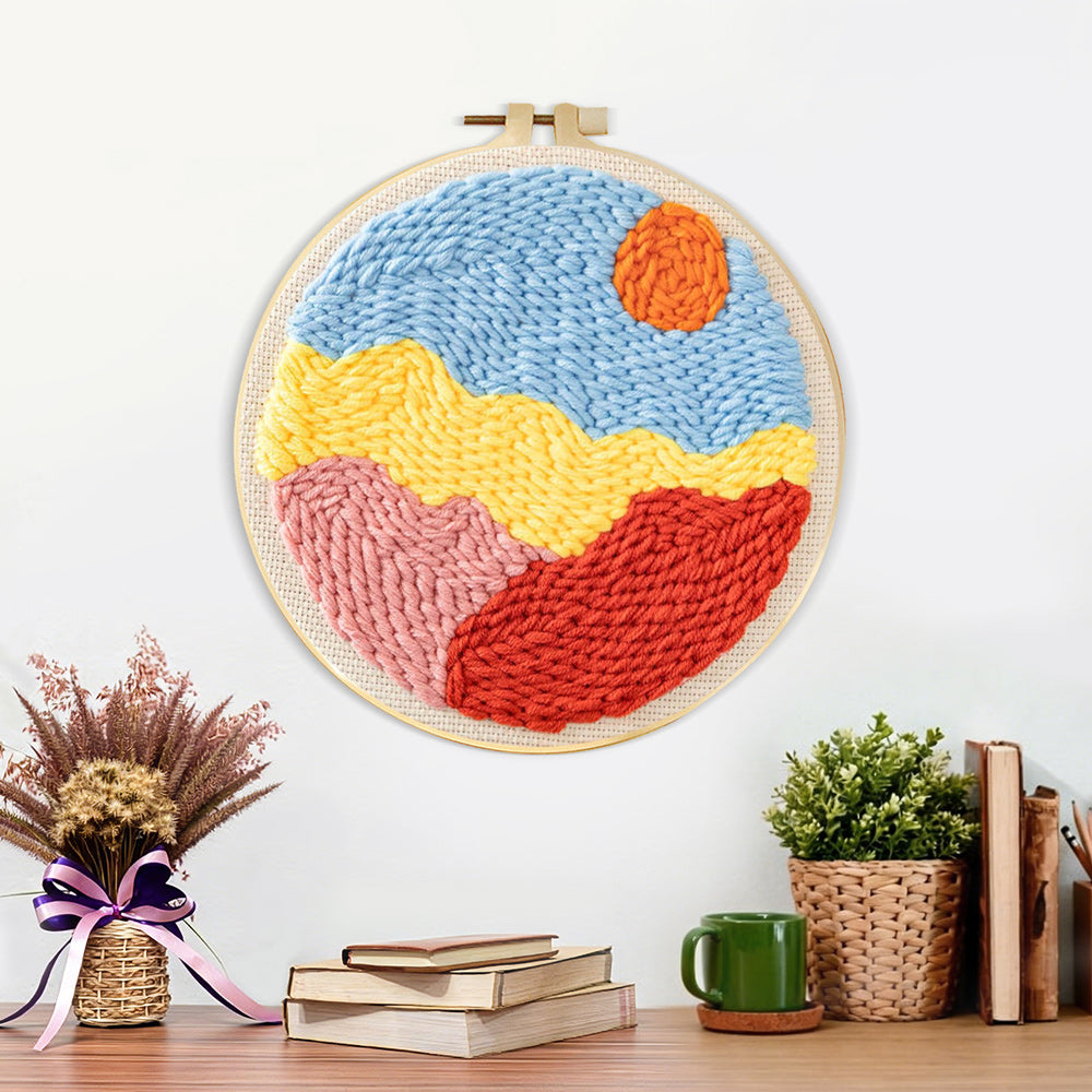 Finished sun over colorful mountains artwork displayed on a wall