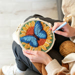 Creating handmade sunflower and blue butterfly punch needle artwork