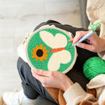 Creating handmade sunflower and white butterfly punch needle artwork