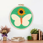 Finished sunflower and white butterfly artwork displayed on a wall