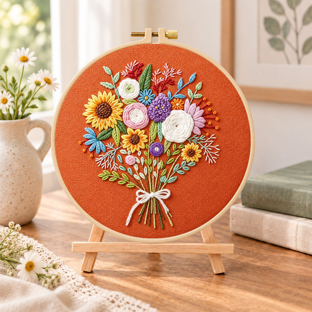 Sunflower bouquet on rust embroidery kit finished hoop displayed on a wooden stand as cozy tabletop decor
