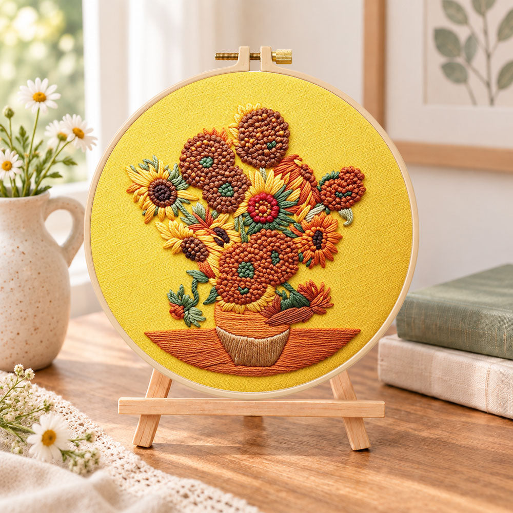 Sunflowers on golden background embroidery kit finished hoop displayed on a wooden stand as cozy tabletop decor
