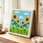 Sunflowers under the sky punch needle artwork displayed on a table
