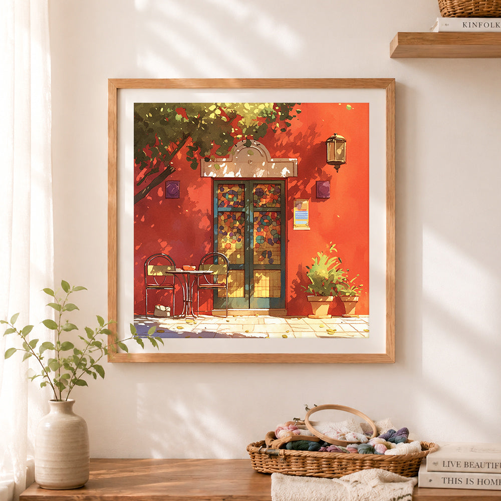 Finished sunlit red wall café scene cross stitch artwork displayed as home decor