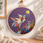 Sunlit underwater koi embroidery hoop wall art displayed as warm and cozy handmade home decor