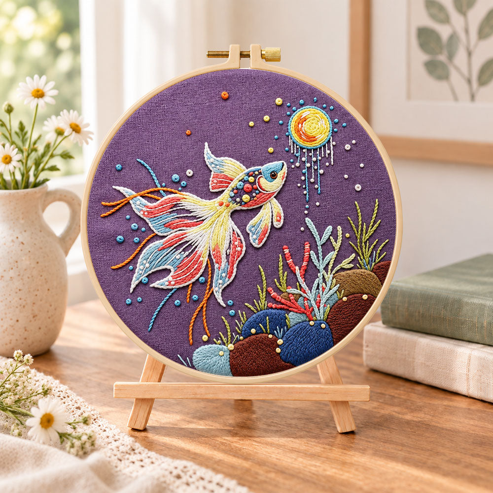 Sunlit underwater koi embroidery kit finished hoop displayed on a wooden stand as cozy tabletop decor