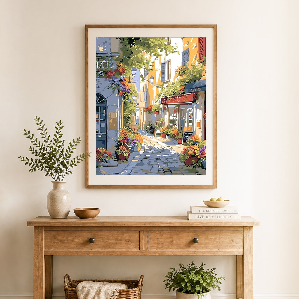 Finished sunny alley with flower shop cross stitch artwork displayed as home decor