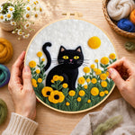 Creating the sunny black cat in yellow flowers wool painting by hand with a felting needle
