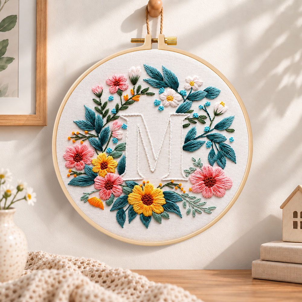 Sunny floral wreath and letter m embroidery hoop wall art displayed as warm and cozy handmade home decor