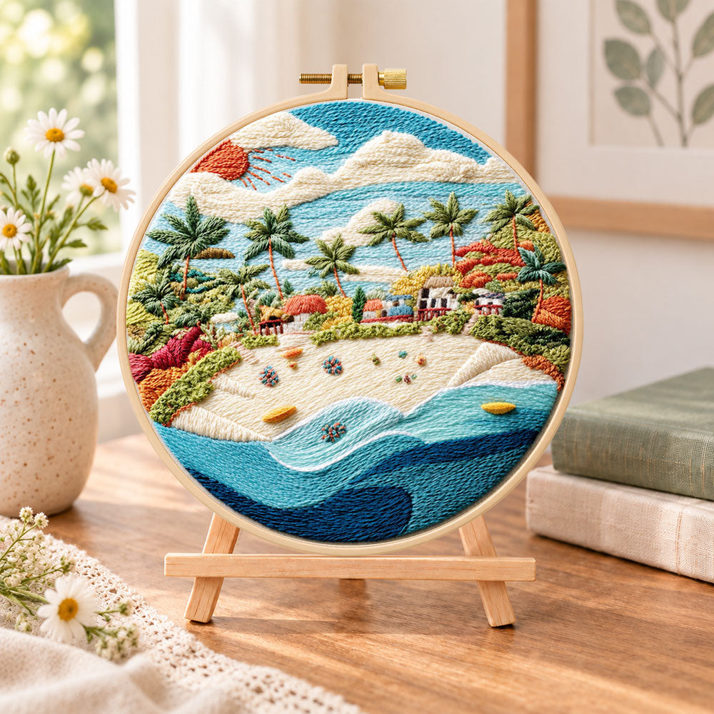 Sunny tropical beach embroidery kit finished hoop displayed on a wooden stand as cozy tabletop decor
