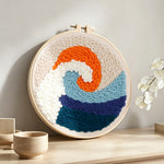 Sunrise waves punch needle artwork displayed on a table